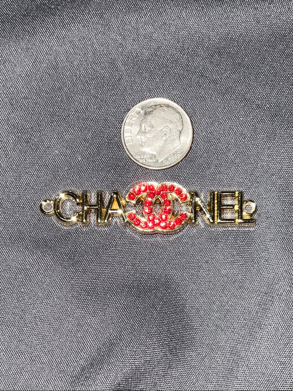 Gold-Tone Brooch with Red Crystal Logo
